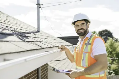 Professional roofing contractor smiling